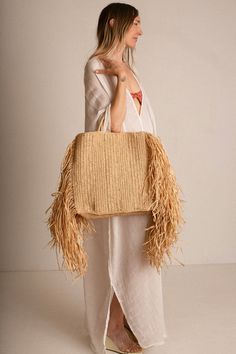 Raffina tote with woven handles, and 12" draped fringe at sides. Tote measures 14.5" wide (without fringe), 16" tall and 4" in depth. Handcrafted in France. Chic Beige Fringe Shoulder Bag, Beige Fringe Tote Shoulder Bag, Beige Fringe Bag For Shopping, Beige Fringe Shoulder Bag For Shopping, Beige Fringe Shopping Bag, Bohemian Straw Bag With Tassels For Shopping, Rectangular Fringe Bags For Shopping, Chic Fringe Tote Beach Bag, Rectangular Fringed Shopping Bag