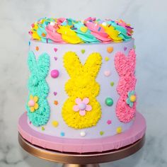 a cake decorated with icing and sprinkles on top of a table