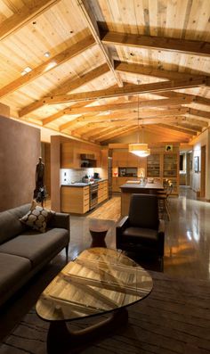 a living room filled with furniture next to a kitchen