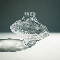 a glass vase sitting on top of a table