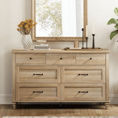 a wooden dresser sitting in front of a mirror on top of a hard wood floor