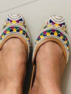 'WHITE BEADED' is an extraordinary jutti intricately hand embroidered by our finest artisans.Silk base with white beads, multi colored embroidered in white pearls, small swarovski beads and gold dabka strings in the front and on the back. Like its name, it's elegant, timeless and graceful!PERFECT FOR ANY OCCASION AND ANY OUTFIT!!*Ethnic Shoes/Women Flats/Handmade Indian Designer Women Shoes or Slippers/Royal shoes/traditional style Women/Wedding Shoes/Bridal ShoesSPECIFICATIONS:•Upper/Panna -Fab Navratri Closed Toe Flats With Mirror Work, Traditional Multicolor Flats With Round Toe, Traditional Flats With Mirror Work For Navratri, Traditional Multicolor Round Toe Flats, Navratri Festival Flats With Gota Work, Navratri Flats With Gota Work For Festival, Traditional Flats With Mirror Work For Festivals, Traditional Multicolor Flats For Festive Occasions, Festive Multicolor Gota Work Flats