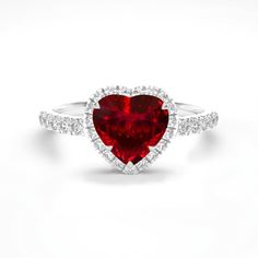 a heart shaped ruby and diamond ring with white diamonds on the band, set in 18k white gold