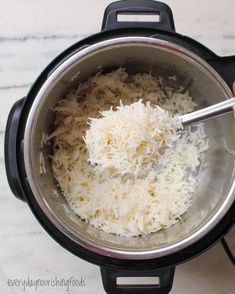 someone is stirring rice in an instant pot