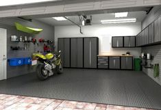 a motorcycle is parked in a garage with lots of cabinets and shelves on the wall