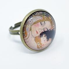 Cabochon Antiqued Brass Color Ring With Mother And Child Graphic Painting Wearable Art Adjustable Ring Size Mother’s Day Mama Mom Life Mom Gift Brand New Shop With Confidence Knowing That Every Item Is Hand Selected And Packaged With Care. Ships Next Business Day! Nickel Free Metal Rings For Gifts, Vintage Adjustable Rings For Gifts, Vintage Adjustable Rings For Gift, Adjustable Vintage Rings For Gifts, Artsy Round Metal Jewelry, Adjustable Ring Jewelry For Mother's Day, Adjustable Wearable Art Jewelry With Artistic Design, Cabochon Open Ring Jewelry Gift, Adjustable Hand Painted Rings For Gift