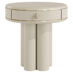 a white table with gold trimmings and two drawers on the top, in front of a white background