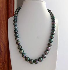 Stunning Tahitian Peacock Pearl Beaded Necklace, 8-10mm, Vivid Green color, Multi-colored Pearls, Very High luster. Perfect size for daily wear.   Classic and Elegant   Lustrous Beauty  Pearl ★ Pearl: Genuine Tahitian pearl, Saltwater  ★ Quality: AA+/AAA ★ Size: 8mm - 10mm ★ Color: Natural Untreated, Vivid Peacock / Intense Green/Multi-colored ★ Shape: Round /Near Round ★ Luster: Very High luster, Wonderful ★ Body:  Nice, Baby Smooth and Mirror Like, Mostly clean (85 with Natural Marks, not visible when wear ★ Necklace Length: 42.5cm/16.7inches Accessories ★ Metal: Sterling Silver Clasp, Easy to use  Shipping FREE with USPS First Class in US Tahitian Pearl Necklace With Round Beads, Green Single Strand Pearl Necklace, Single Strand Green Pearl Necklace, Green Single Strand Pearl Necklace With Round Beads, Green Pearl Necklace With Polished Round Beads, Colored Pearls, Nice Baby, Peacock Pearl, Pearl Beaded Necklace