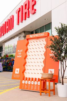 an orange sign sitting on the side of a building next to a potted plant