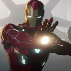 an iron man standing in front of a white wall with his hands out to the side