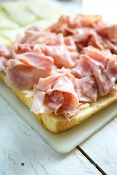 ham and cheese are on top of a piece of bread