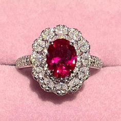 Moissanite and Lab Ruby Cluster Halo Ring, Sterling Silver full of D VVS1 Moissanite encircling a Perfect 2.0 Carat Oval Lab Ruby. All Stones in the halo, shank and band are Moissanite. Total weight is 1.5 carats with a 4*8mm 2.0 carat Ruby center statge. The play on light with this combination is enchanting. All fire and sparkle on a solid thick Fine SIlver setting that has been dipped 3 times in 18K Whte Palladium Gold. size 8 is photographed and ready to ship. I ship in 24 to 48 hours if you'd like a different size, please contact me and I'd be happy to make it for you. The ring featured in the pictures is the actual ring you'll receive if you purchased this listing and it comes in a size 8. Feel free to message me with questions. Luxury Ruby Diamond Ring With Halo, Luxury Ruby Ring With Diamond Halo, Luxury Ruby Halo Diamond Ring, Dazzling Round Ruby Ring With Halo Setting, Dazzling Ruby Ring With Halo Setting, Fine Jewelry Moissanite Ruby Ring, White Gold Ruby Ring With Cubic Zirconia Halo Design, Cubic Zirconia Ruby Ring With Halo Design, White Gold Ruby Ring With Halo