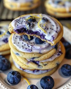 a stack of blueberry cookies with icing and sprinkles on a plate