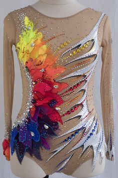 a woman's bodysuit with multicolored flowers and sequins on it