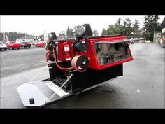 a red and black truck parked in a parking lot