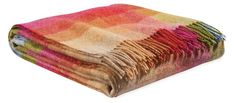 a multicolored blanket folded on top of each other