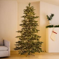 a small christmas tree in the corner of a room