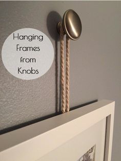 hanging frames from knobs on the wall