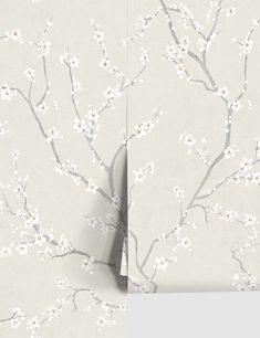 the wallpaper is decorated with white flowers and branches on grey background, as well as an image of a tree in blossom