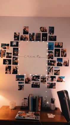 a desk with pictures on the wall and lights strung from it's sides to spell out create