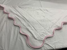 a white sheet with pink trim on it