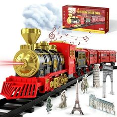 a toy train with music and figurines on the tracks next to an eiffel tower