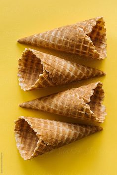 three cones of ice cream on a yellow background by julia rabe for stocksy