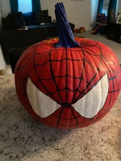 a spiderman pumpkin sitting on top of a counter