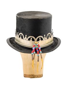 TIP OF THE HAT! This incredible piece is a one-of-a-kind vintage collector. Dating back to the mid-20th century, the felt top hat is adorned with a reproduction Hudson Bay trade crown crafted from German silver and embellished with glass trade beads and tin cones. While it’s possible to wear, its age and rarity make it more suited as a piece of unique decor. hallmarks: Pantke-Harpke Company materials: felt, German silver, glass trade beads, leather, tin cones dimensions: 10.0" W x 6.0" H x 12.0" Crown Crafts, Collar Tips, Crown Vintage, Hudson Bay, Cashmere Accessories, Stocking Gifts, Trade Beads, German Silver, Silver Accessories