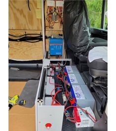 the inside of a vehicle with many wires and equipment in it's back compartment