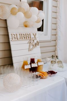 a table topped with drinks and balloons