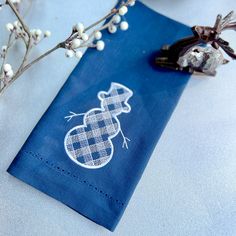 a blue napkin with an embroidered design on it