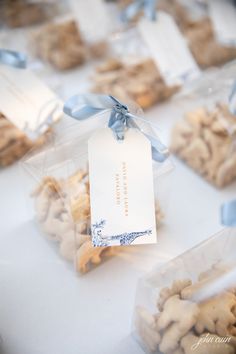 some cookies are wrapped in plastic bags and tied with a blue ribbon on the table