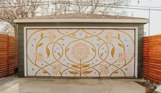 a garage door painted with orange and white flowers