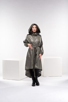 "This cyberpunk rain jacket has an asymmetrical design longer on the back and shorter on the front. It has a long double-side zipper along with two side pockets and a long belt to adjust the waistline to your personal needs and fashion style. The elastic finishes on the sleeve and the light fabric make this raincoat a \"must-have\" fashion piece for the season. ◼ FIT This cyberpunk jacket is of a loose fit. To have the same look as on our model, please check our body measurements size chart below and choose the correct size for you. ◾The model in the picture is wearing size XS in an Olive green color. ◼ FABRIC ◾polyester ◼ INFO: ◾ Worldwide express shipping - please provide a phone number for shipping documents ◼ CARE ◾ hand wash ◾ cold water 30 degrees ◾ do not iron ◼ CUSTOMIZATION ◾Don't Oversized Hooded Nylon Raincoat, Goth Jacket, Cyberpunk Jacket, Winter Raincoat With Double-lined Hood In Nylon, Steampunk Coat, Long Sleeve Raincoat With Double-lined Hood, Plus Size Goth, Black Nylon Raincoat With Double-lined Hood, Rain Cape