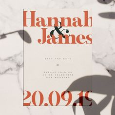 an orange and black save the date card on a marble surface with shadows from flowers