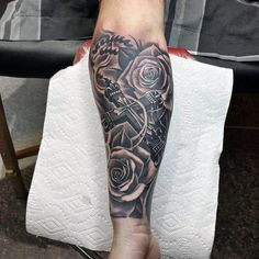 a person with a tattoo on their leg and foot is holding a cell phone in his hand