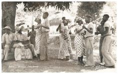 a group of women standing next to each other under a tree