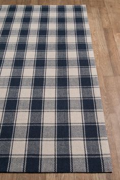 a blue and white plaid rug on the floor