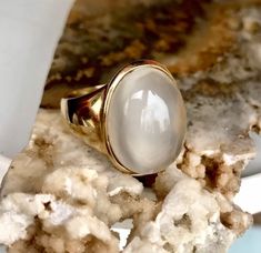 This is a glorious natural cats eye moonstone set in 14K gold. In excellent vintage condition.  14K gold solid gold marked and tested. Size 5.5 and easily sizable by your local jeweler. Top grade natural cats eye moonstone. Transparency, clean and bright.  Approximately 10 CT Moonstone. Measures approximately 12.5mm x 16.5 mm x 7mm. Ring weighs 5.5 grams. Moonstone aids in emotional stability. Most importantly, to help one connect with their higher self through the waves of emotions. To be in to Vintage Cabochon Moonstone Ring For Anniversary, Elegant Untreated Moonstone Ring, Elegant Oval Moonstone Ring In Chalcedony, Vintage Moonstone Gemstone Ring, Elegant Oval Moonstone Chalcedony Ring, Handmade Moonstone Ring For Anniversary, Antique Oval Moonstone Ring Handmade, Handmade Antique Oval Moonstone Ring, Antique Oval Moonstone Ring