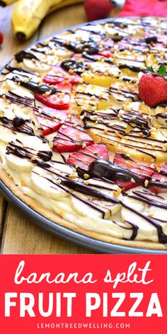 a banana split fruit pizza with chocolate drizzle and strawberries