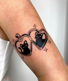 two cats in a heart tattoo on the arm