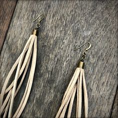 "-Here's a vegan twist on our popular leather tassel earrings. Same Western/Boho flare but with faux-leather instead of deerskin. These soft tassel earrings give a big kick to any outfit. -Dramatic but lightweight enough to wear every day. -9\" total length. -Earwires are antique-brass. Goldfill earwires are available by request. -100% vegan leather. -Ok to get wet. -Available in 5 colors. -Designed and handmade in South Pasadena, CA. Check out more of our lovely earrings here: https://www.etsy. Leather Tassel Earrings, Aries Pendant, Beige Earrings, Leather Earring, South Pasadena, Western Boho, Deer Skin, Eco Friendly Fashion, Lovely Earrings