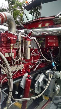 the front end of a fire truck with hoses attached to it's engine