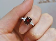 Emerald Cut Natural Garnet ring, made with 925 sterling silver, plated with white gold, beautiful promise ring, special gift for anniversary.Main Stone: Natural GarnetCut: EmeraldMeasurerment: 6*8 mm Side Stone: CZCS0328 Beautiful Promise Rings, Garnet Ring Silver, Garnet Engagement Ring, Stackable Rings Wedding, Red Garnet Ring, Mom Ring, Diamond Cluster Engagement Ring, Topaz Engagement Ring, London Blue Topaz Ring