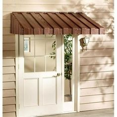 a white door with a brown awning over it