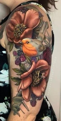 a woman's arm with flowers and birds on it