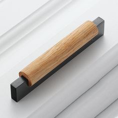 a wooden handle on the side of a white building