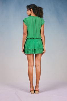 Done in a verdant shade, this short-sleeve mini dress ties up at the neckline and cinches in at the waist before falling to a thigh-skimming tiered hem with crisp, raw edges. The perfect one-and-done number for date night - not to mention one of Current Air's most popular dress. •V-neckline with tie •Relaxed fit •Ruffle trim •Pleated cap sleeves •Elasticized waist •Tiered pleated skirt •Raw edges Item number 1990061-1100% Polyester Dry clean Imported Green Mini Dress With Ruffle Hem, Summer Tiered Dress With Short Sleeves, Green Knee-length Mini Dress With Ruffle Hem, Summer Mini Dress With Pleated Hem And Short Sleeves, Short Sleeve Mini Dress With Pleated Hem For Summer, Chic Green Knee-length Short Sleeve Dress, Chic Green Mini Dress With Ruffle Hem, Fitted Green Short Sleeve Dress For Spring, Green V-neck Short Sleeve Dress For Spring