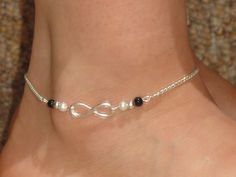 Black and white ankle bracelet, Onyx and pearl infinity anklet This listing is for a silver plated ankle bracelet with an infinity symbol connector. On each side of the infinity connector are black onyx gemstones and white pearl beads seperated by a silver round bead. The length of the Ankle Bracelet Ideas, Elegant Flexible Silver Anklets, Elegant Flexible Anklets As Gift, Elegant Flexible Anklets For Gifts, Ankle Accessories, Pearl Ankle Bracelet, Infinity Anklet, Pandora Bracelet Designs, Memory Wire Jewelry